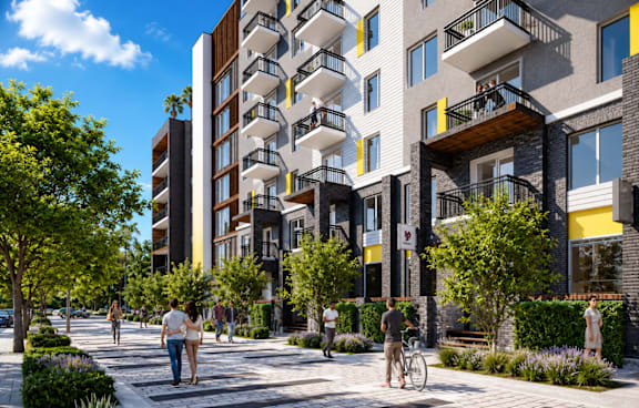 A modern apartment complex with balconies and a pedestrian walkway.