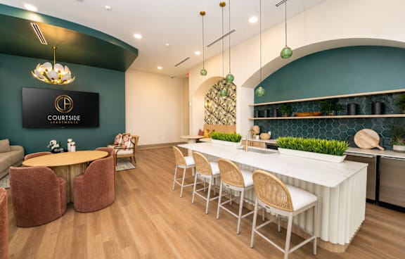 A modern dining area with a bar and chairs.