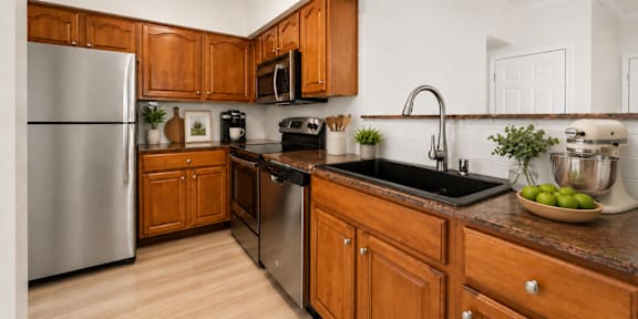 a kitchen with wooden cabinets and stainless steel appliances