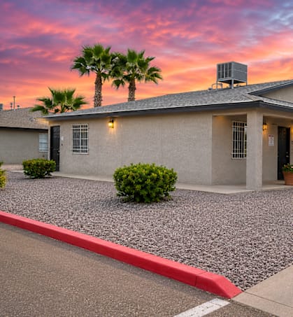A house with a red curb in front of it.