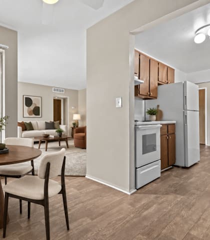 A modern kitchen with a dining table set for four.