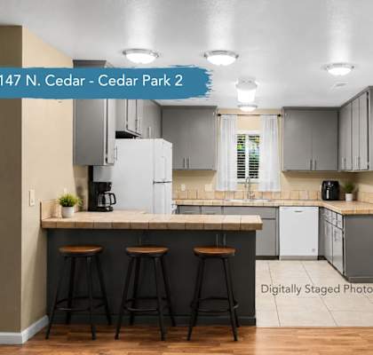 A kitchen with a bar area and a dining table.