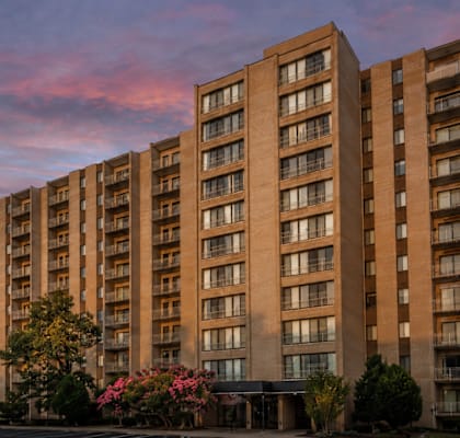 A large apartment building with balconies and windows is shown.