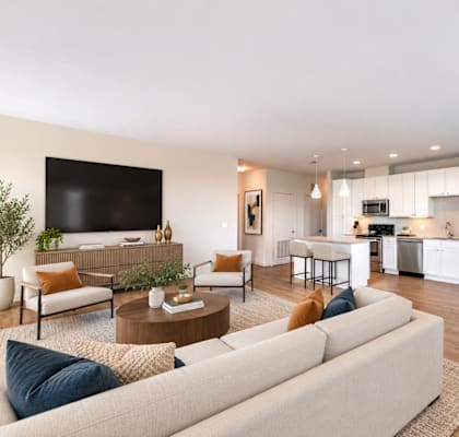 A modern living room with a white sofa and a television.