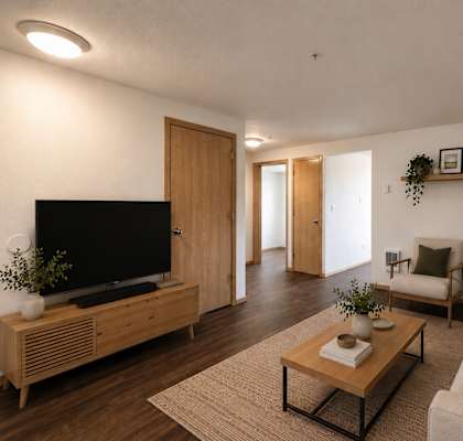 A living room with a television, couch, and coffee table.