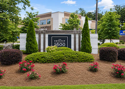 A sign that says "EMERSON 1600" is in front of a building.