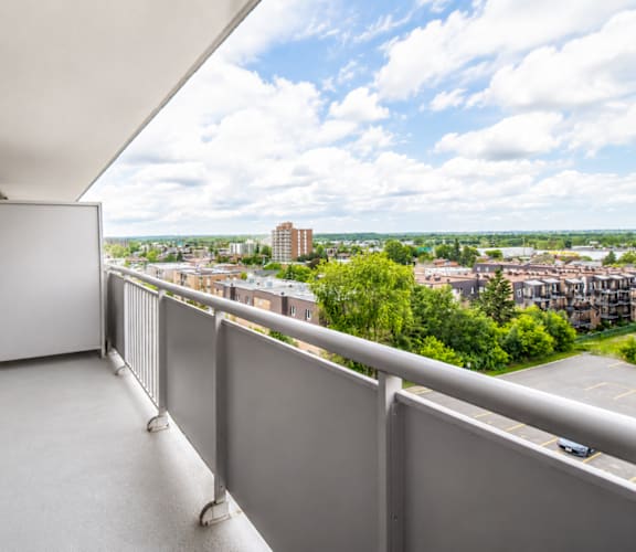 A balcony with a view of a cityscape.