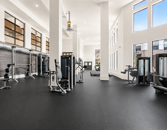 A spacious gym with a variety of equipment.