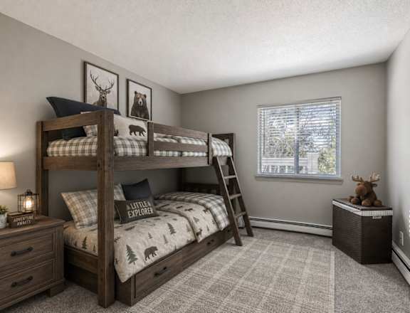 A bedroom with a bunk bed and a ladder.