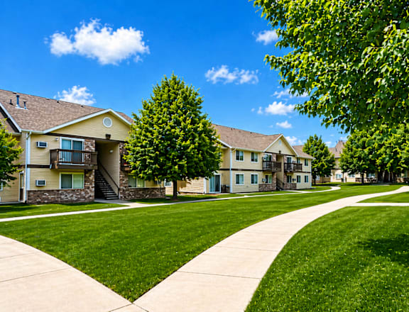 A sunny day at a residential area with houses and green lawns.