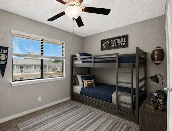 A room with a bunk bed and a ceiling fan.
