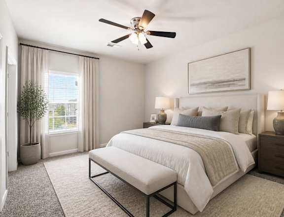 A bedroom with a large bed, a ceiling fan, and a window with curtains.