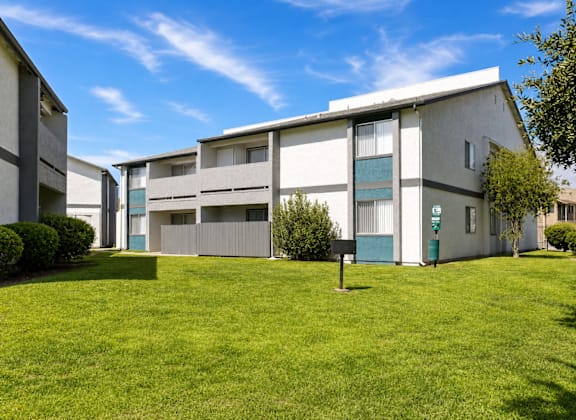 A building with a green lawn in front of it.