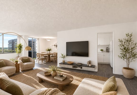 A living room with a large flat screen TV mounted on the wall.