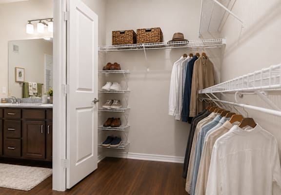 Spacious bedroom with ceiling fan, large windows, and modern finishes in a one-bedroom apartment at Auberge of Tyler.