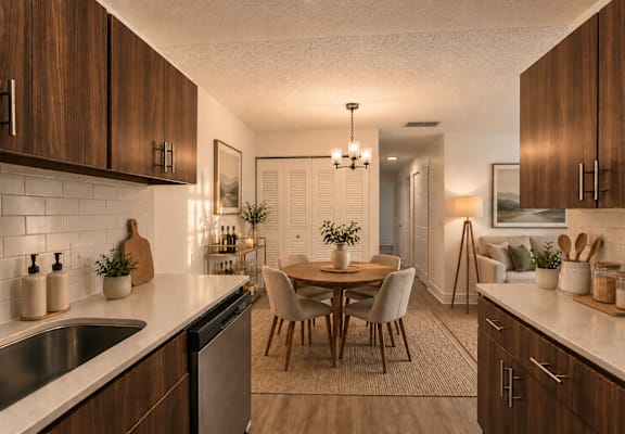 A kitchen with wooden cabinets and a dining table.
