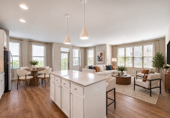 A modern kitchen with white cabinets and a large island.