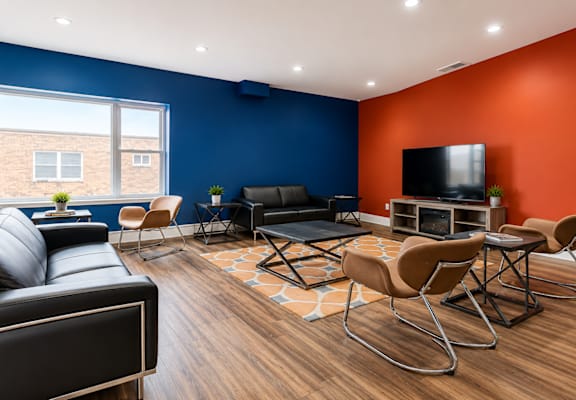A living room with a black leather couch, a black chair, a black sofa, a black coffee table, a black TV, a black rug, a black floor lamp, a black wall, a black window, a black door,