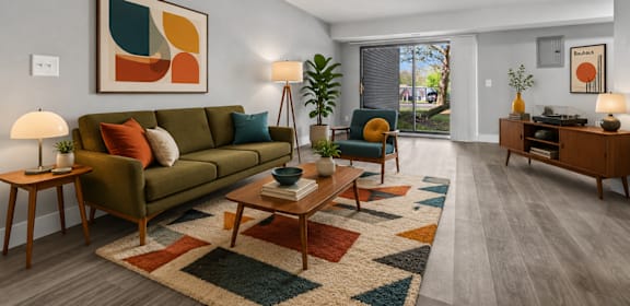 A living room with a green couch, a coffee table, and a rug.