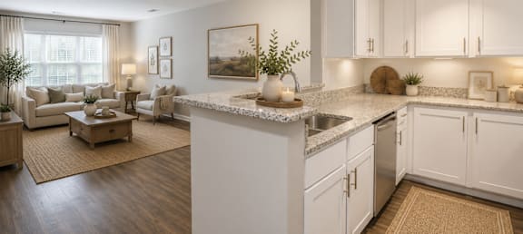 A kitchen with white cabinets and a marble countertop.