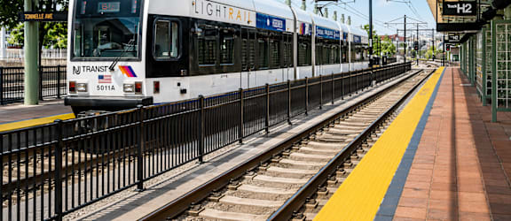 A train on the tracks with the words Flightrail on the front.