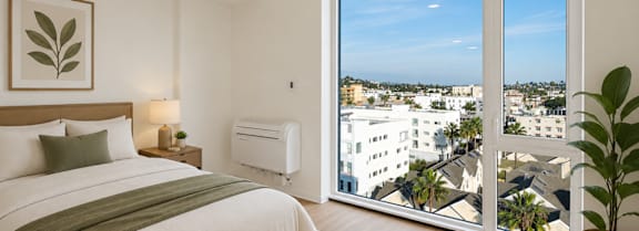 A bedroom with a large bed and a view of the city.