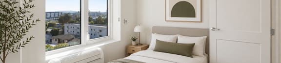 A studio bedroom with a large bed and a view of the city.