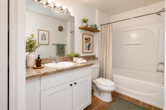 A white bathroom with a sink, toilet, and bathtub.