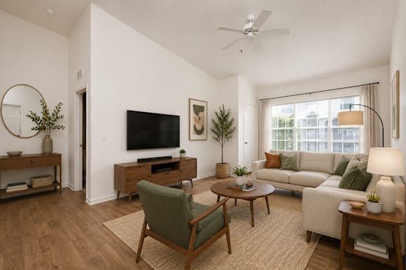A living room with a green chair and a white couch.