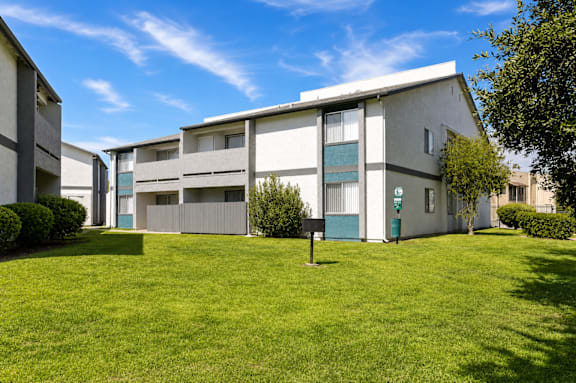 A building with a green lawn in front of it.