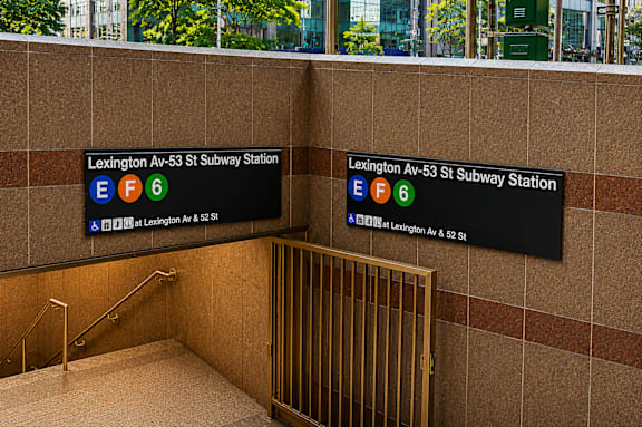 A subway station entrance with a sign that says Lexington Av-53 St Subway Station.