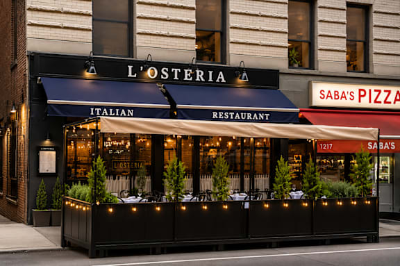 A restaurant named L'Osteria is located next to a pizza shop.