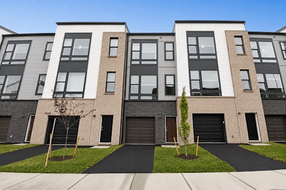 A modern apartment building with a black and white facade.