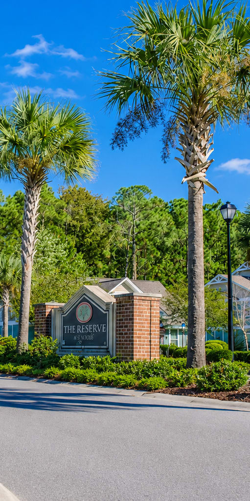 A street view of a residential area with a sign that reads "The Grove".