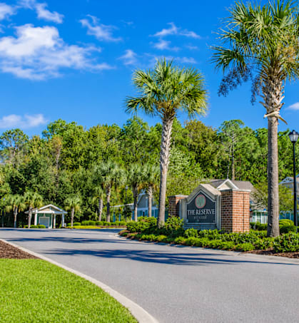 A street view of a residential area with a sign that reads "The Grove".