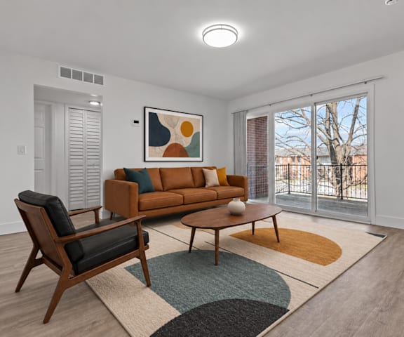 A living room with a brown couch, a chair, and a coffee table.