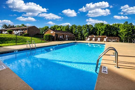 A large swimming pool with a ladder on the side.