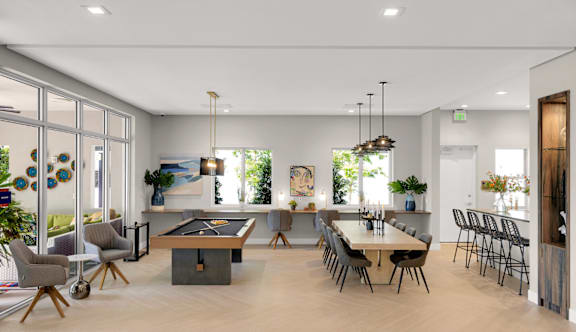 a living room with a table and chairs and a dining room