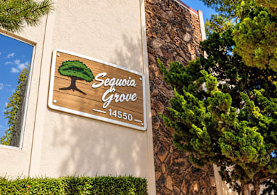 A sign for Sequoia Grove is mounted on a wall.