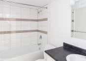 Thumbnail 6 of 7 - a bathroom with a bathtub and a sink