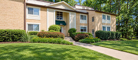 A building with a green lawn in front.