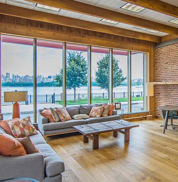 A living room with a grey couch and a wooden coffee table.