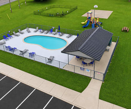 A playground with a blue pool and a slide.