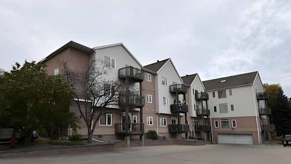 Apartment complex with multiple buildings and balconies. at Eighth Street Manor  Apartments, Fargo, ND