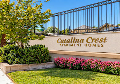 A sign that says "Crestline Crest Apartment Homes" is on a wall.