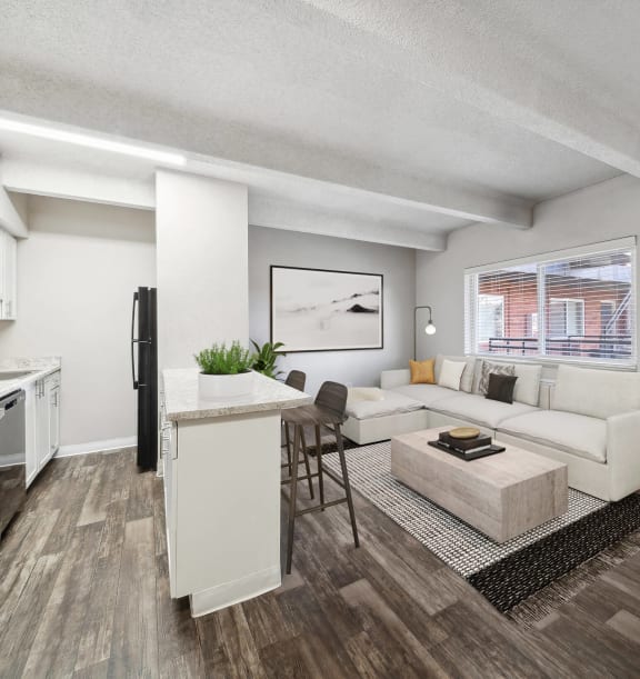 Model Kitchen and Dining Room Area with Wood-Style Flooring at Esprit Cherry Creek Apartments in Glendale, CO-WELCOME.