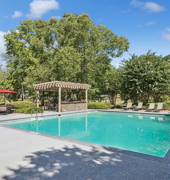 Community Swimming Pool with Pool Furniture at Lakeside Retreat Apartments located in Peachtree Corners, GA-WELCOME.