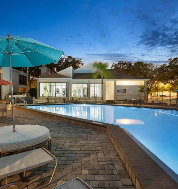Community Swimming Pool with Pool Furniture at Haven at Water's Edge Apartments in Tampa, FL-WELCOME.