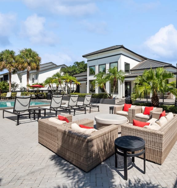 Community Swimming Pool with Lounge Furniture at Rosehill Preserve Apartments located in Orlando, FL-WELCOME.