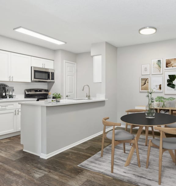 Model Dining Room with Wood-Style Flooring and View of Kitchen at Grand Pavilion Apartments in Tampa, FL-WELCOME.